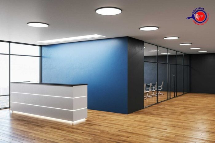 Freshly painted commercial office with modern furniture and bright lighting.