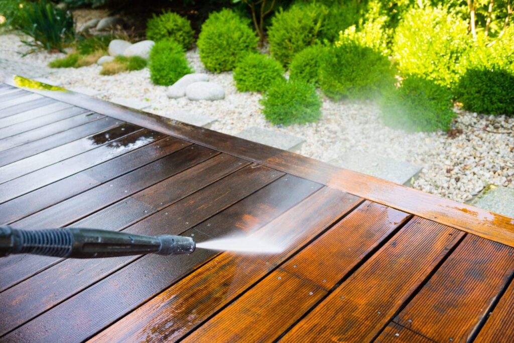 Before and after images of a deck cleaned with professional power washing service.
