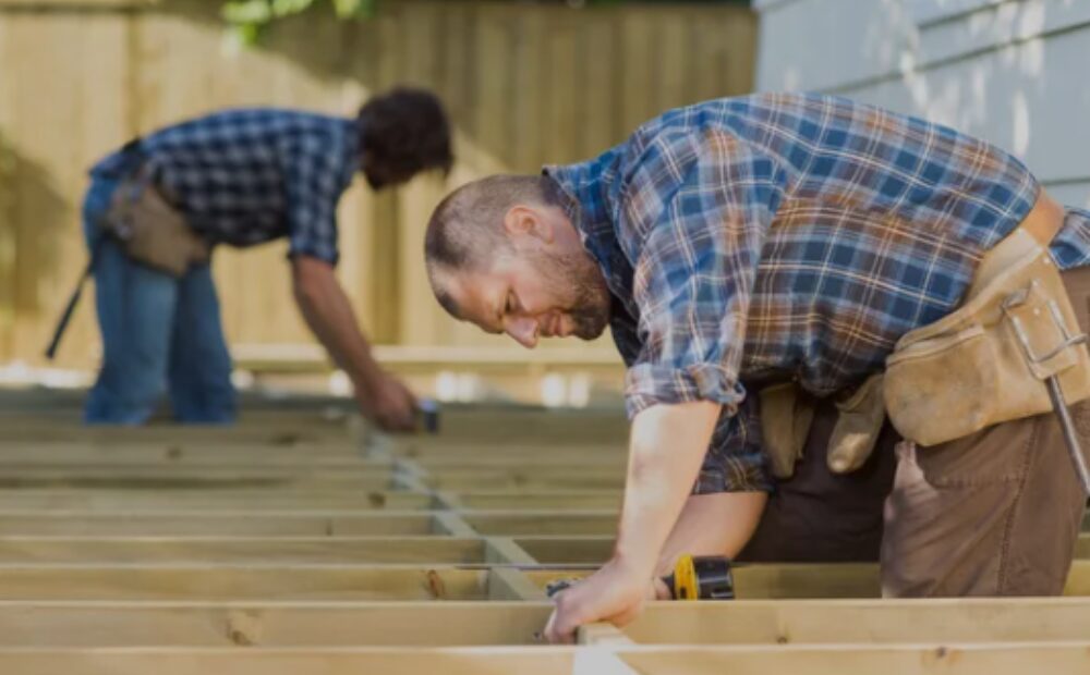 Carpenter performing carpentry work on a deck