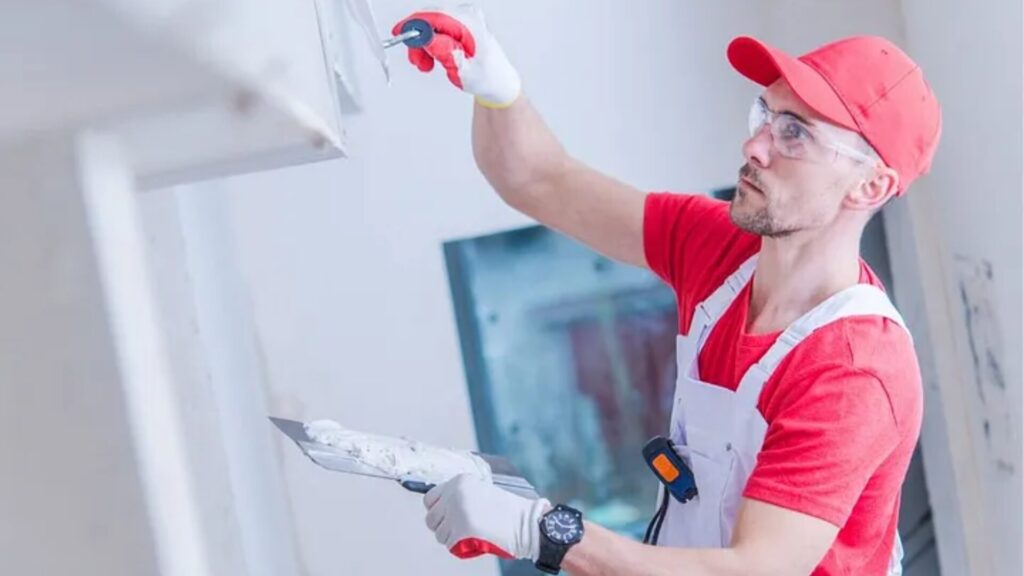 Professional carpenter performing drywall services in a residential home.